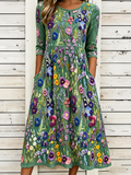 Vestido midi verde con estampado floral multicolor, cuello redondo y manga 3/4
