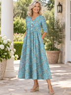 Vestido midi de media manga con cuello en V, estampado floral y pliegues, con bolsillos