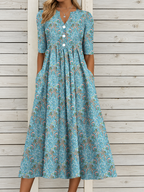 Vestido midi de media manga con cuello en V, estampado floral y pliegues, con bolsillos