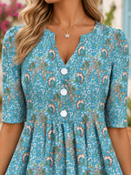 Vestido midi de media manga con cuello en V, estampado floral y pliegues, con bolsillos