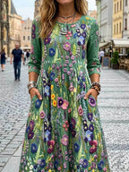 Vestido midi verde con estampado floral multicolor, cuello redondo y manga 3/4