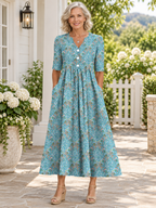 Vestido midi de media manga con cuello en V, estampado floral y pliegues, con bolsillos