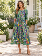 Vestido midi verde con estampado floral multicolor, cuello redondo y manga 3/4
